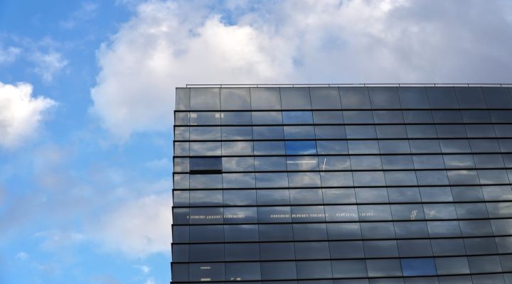Glass office building against a blue sky